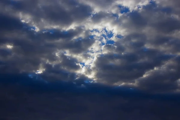 View on beautiful white and gray clouds in a blue sky. Clouds and Skies in the afternoon. The Sun behind Clouds. Fresh Air. Cloudy Weather. Cloud Formations