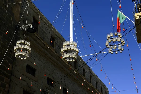 Glass bottle chandeliers high above the street — Stock Photo, Image