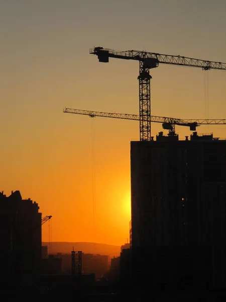 The shadow of the building and crane.  Urban landscape with golden skylight during sunset.