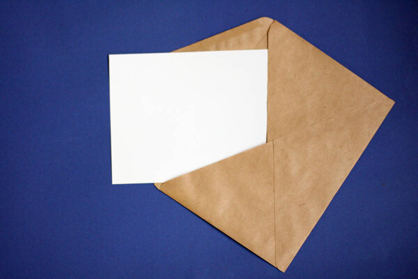 Mockup with envelope, blank card on blue table