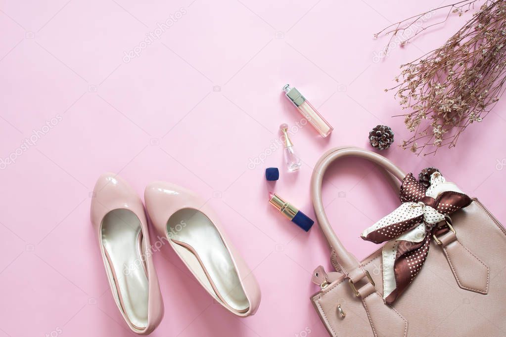 Fashion Design Woman Accessories Set. Cosmetic Makeup. Stylish hand bag and shoes on pink color background, Top view