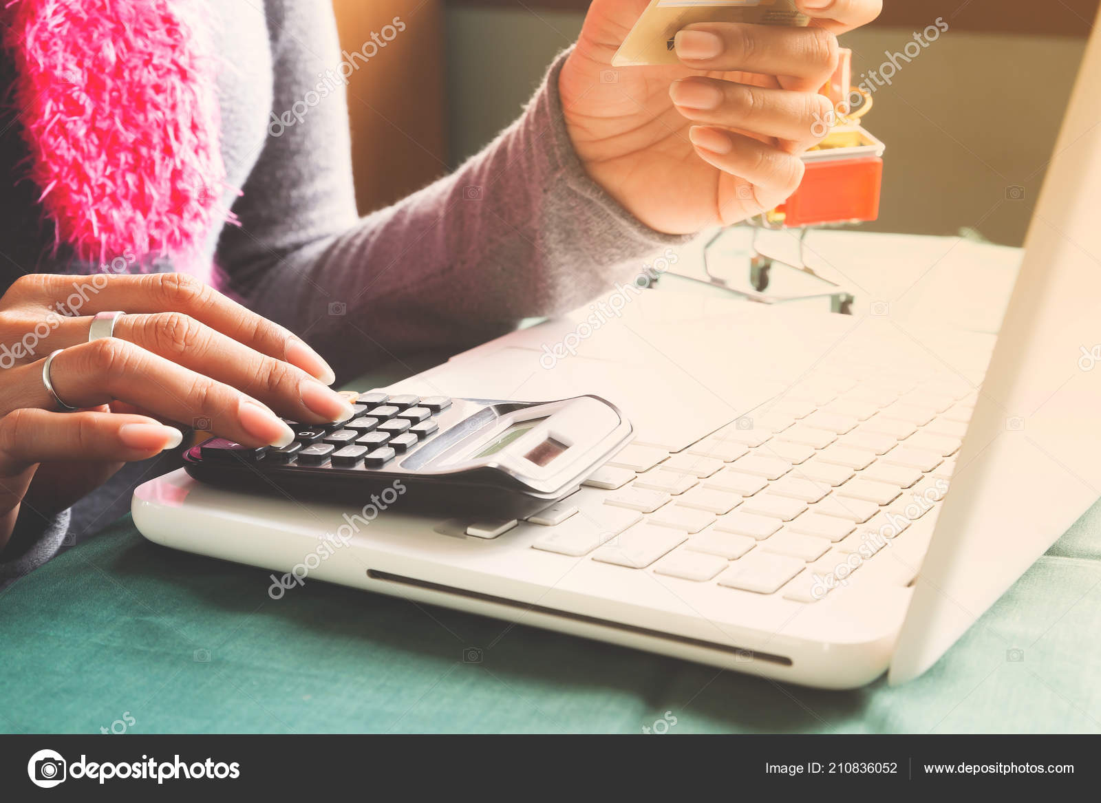 woman using laptop calculator holding credit card online shopping online credit card calculator