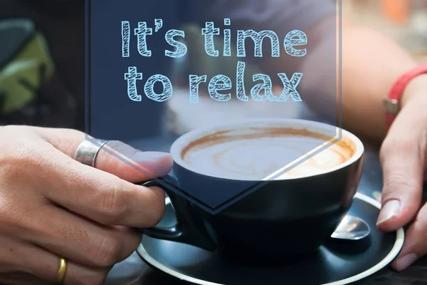 It\'s time to relax typography on image of hand holding cup of coffee