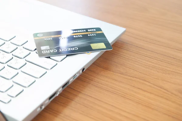 Credit card on laptop computer. Online shopping, paying, buying, commercial concept, e-payment. Selective focus. — Stock Photo, Image