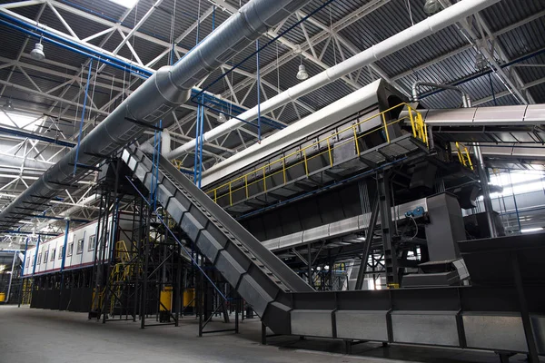 Central conveyor of the waste sorting plant. Recycling and storage of waste for further disposal.