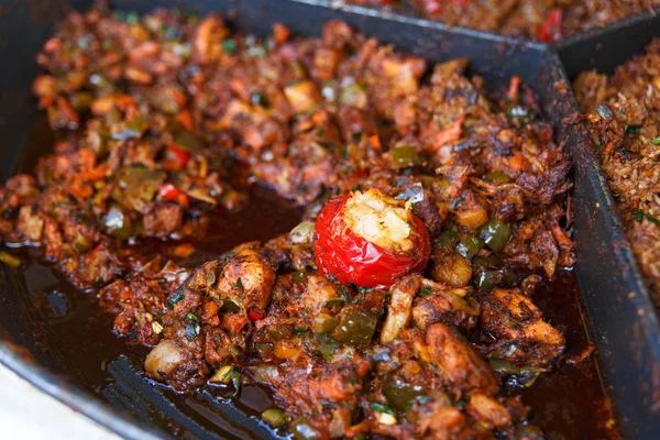 Process of cooking european traditional meat stew. Big plate of fried meat with vegetables. Chef cooking on the street during the holiday of the city Druskininkai, Lithuania.