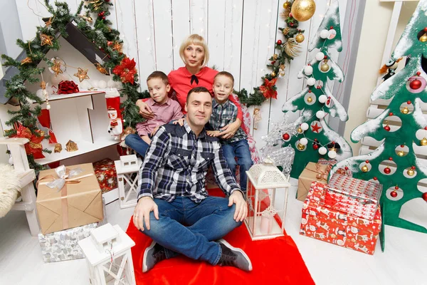 Stylish happy family celebrating christmas in home over christmas tree