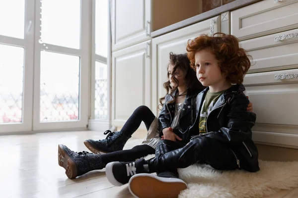 Oğlan ve kız arkadaşlar birlikte yere oturup oynamak.