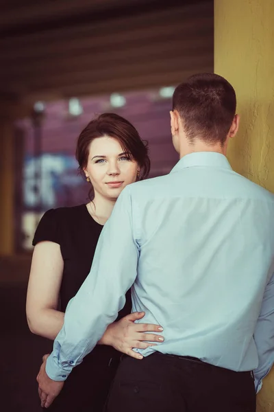 Portrait of young woman looking from behind the shoulder of her boyfriend — Stock Photo, Image