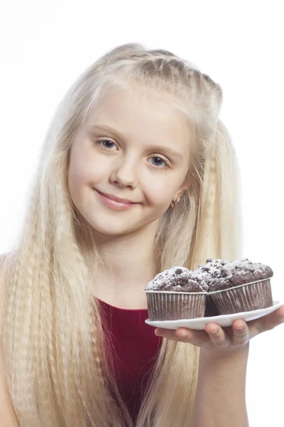 Girl holds chocolate muffins — Stock Photo, Image