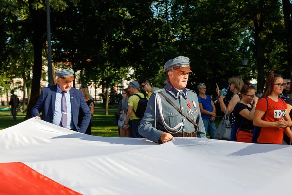 People holding big Polish flag — 图库照片