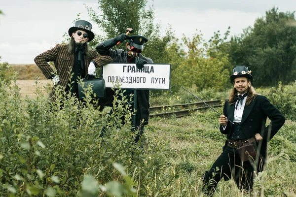 Three Men Steampunk Suits Pose Abandoned Railway — Stock Photo, Image