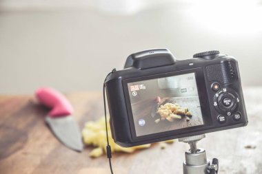 Camera shooting a photo of chopped potatoes on a wooden surface with a knife on the side clipart