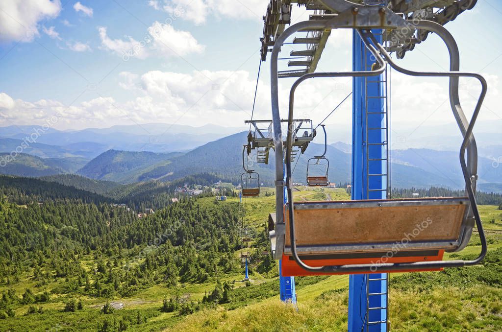 Scenic view of  ski lift over field and forest in Carpathian mountains ,Dragobrat, Ukraine. Travel adventure and hiking activity  lifestyle in summer 
