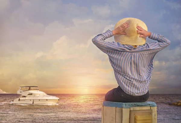 Back view of  happy young woman sitting on beach rocks   at sunset .Cyprus , Ayia-napa — Stock Photo, Image