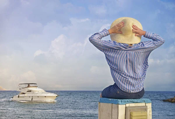 Back View Happy Young Woman Sitting Beach Rocks Sea Boat Стоковое Фото