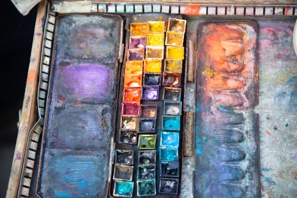 Artist palette with various colors, painter's palette in the workplace with colors. Palette of colors, creative disorder, art.