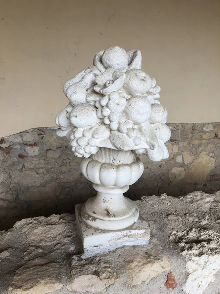 statue cup with fruit in plaster, garden decoration