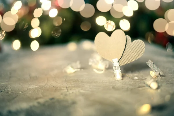 Вирізати серця на дерев'яному столі проти осквернених різдвяних вогнів — стокове фото