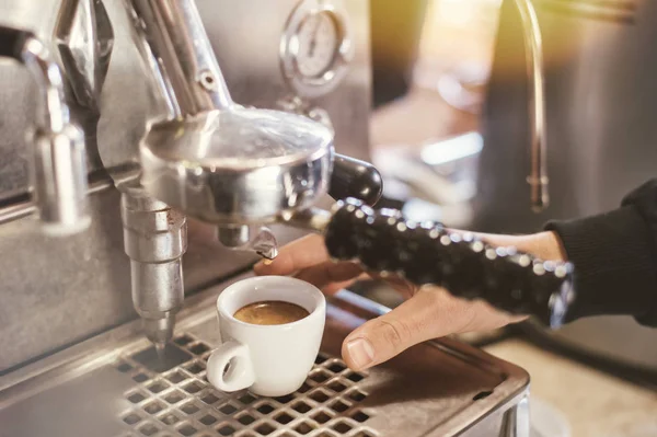 Proffessional brewing - coffee bar details. Espresso coffee pouring from espresso machine.