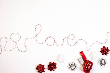 beyaz zemin üzerine kırmızı kurdele yapılmış kelime aşk