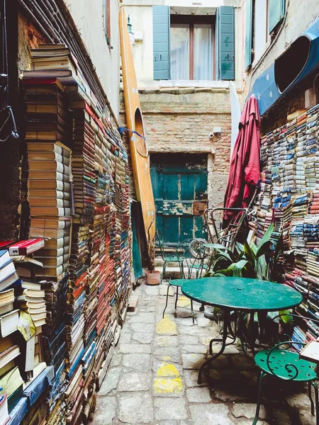 Venice Italy. March 2019: Aqua alta bookstore of second hand books, situated at the canal entrance and being overflooded several times a year — Stock Photo, Image