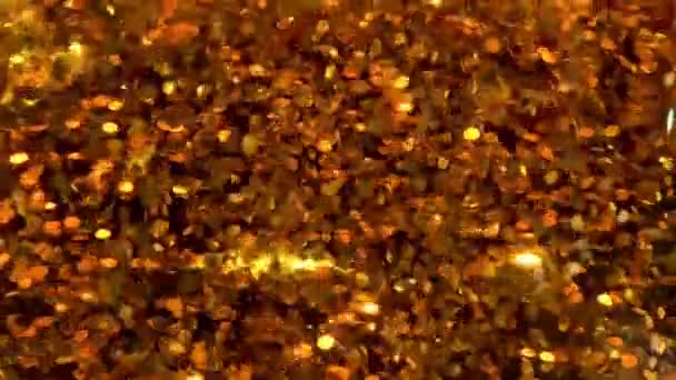 พื้นหลังแวววาวสีทองที่มีผลส่องแสงสว่าง confetti — วีดีโอสต็อก