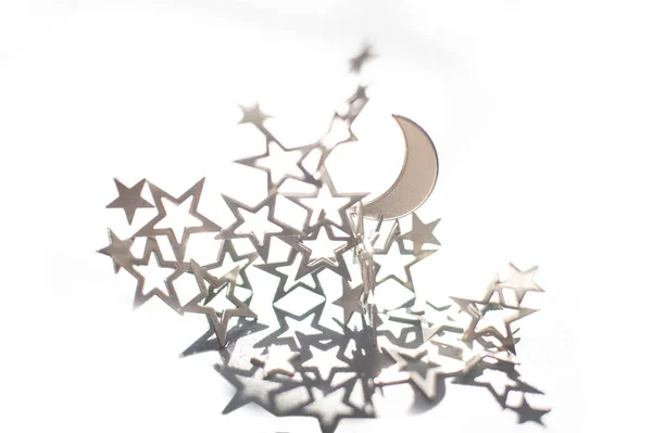 Silver half-moon and stars on white background