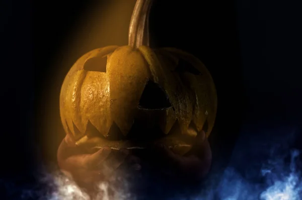 Scary Halloween pumpkin on black background. Scary glowing face trick or treat — Stock Photo, Image