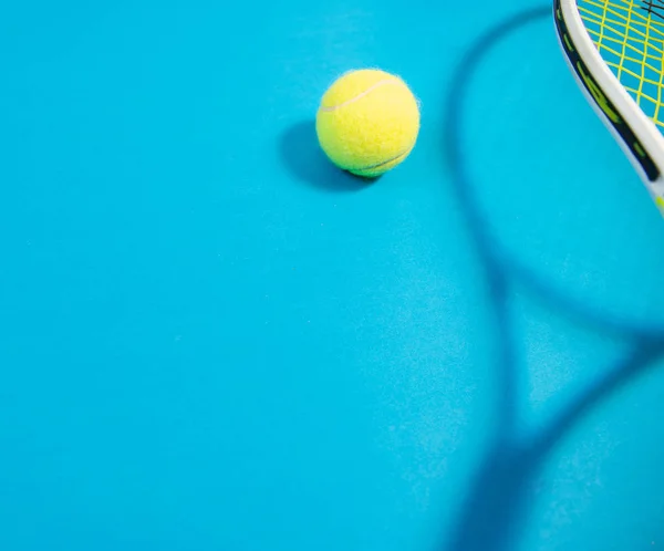 Tennis racket and ball sports on blue background