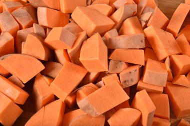 Overhead view of cubed raw sweet potatoes clipart