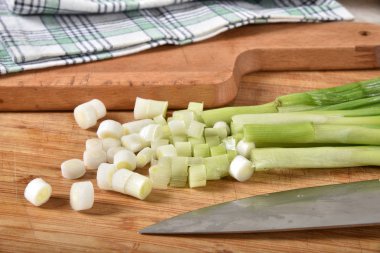 Frsh organik doğranmış yeşil onionson bir kesme tahtası