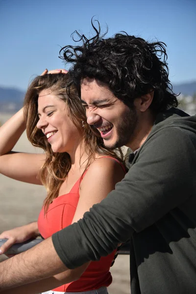 Romantic young couple laughing while on vacation