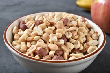 A bowl of dry roasted salted peanuts clipart