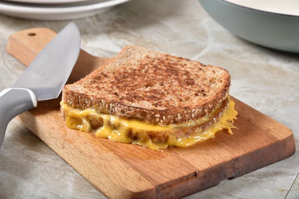 Grilled cheese sandwich on a cutting board — Stock Photo, Image