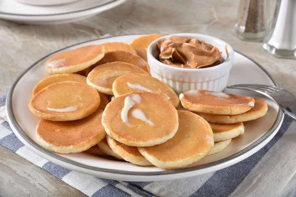 Mini pancakes with peanut butter — Stock Photo, Image