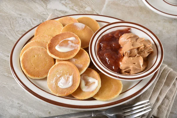 Mini pancakes with peanut butter and jam — Stock Photo, Image