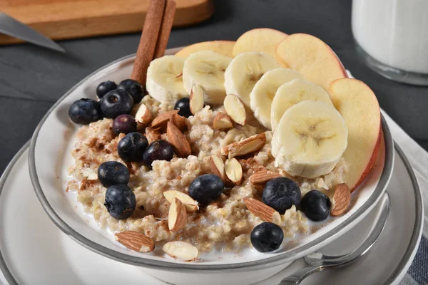 Oatmeal with fruit and nuts — Stock Photo, Image