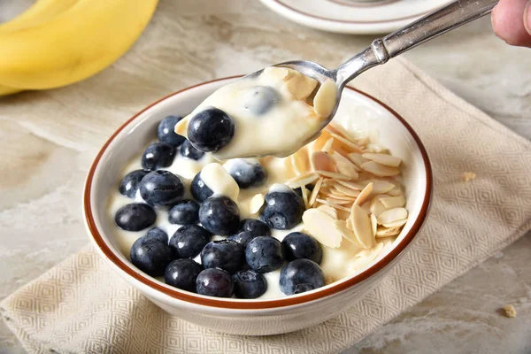 Eating blueberry yogurt — Stock Photo, Image