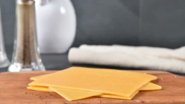 Bir kesme tahtası üzerinde çedar peyniri dilimleri istifleme, hareket durdurmak