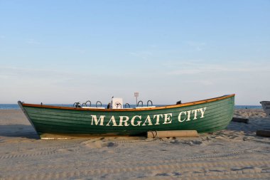Rowboat marks the section of beach belonging to Margate New Jers clipart