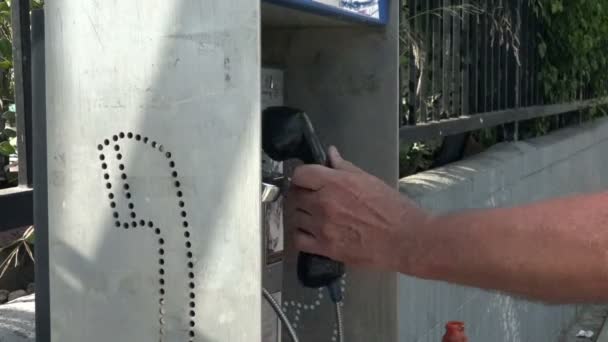 Closeup Man Putting Coins Pay Phone — Stock Video