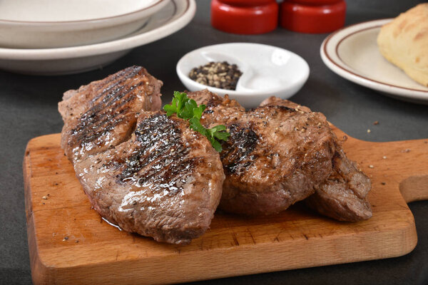 Juicy grilled top sirloin steaks on a cutting board