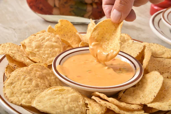 Round corn chips with cheese sauce — Stock Photo, Image