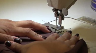 Profesyonel terzi başlangıçta dikişleri kilitliyor, ağır çekimde.