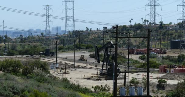 Pump Jacks Large Oil Field Los Angeles Skyline Distance — Stock video