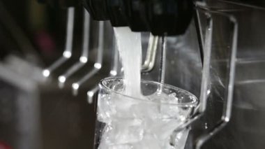 Filling a glass at a soda fountain in a restaurant