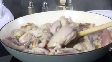 Cooking cubed chicken breast in a skillet