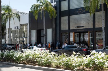 Beverly Hills, CA / USA - 12 Temmuz 2020: Yüz maskeli müşteriler Rodeo Drive 'da lüks mağazaların önünde bekliyor