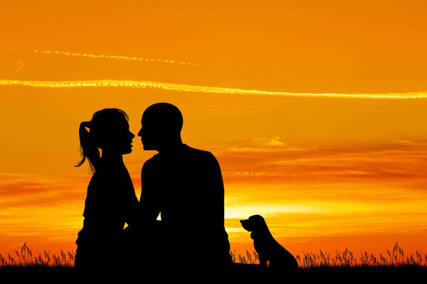 loving couple kissing at sunset